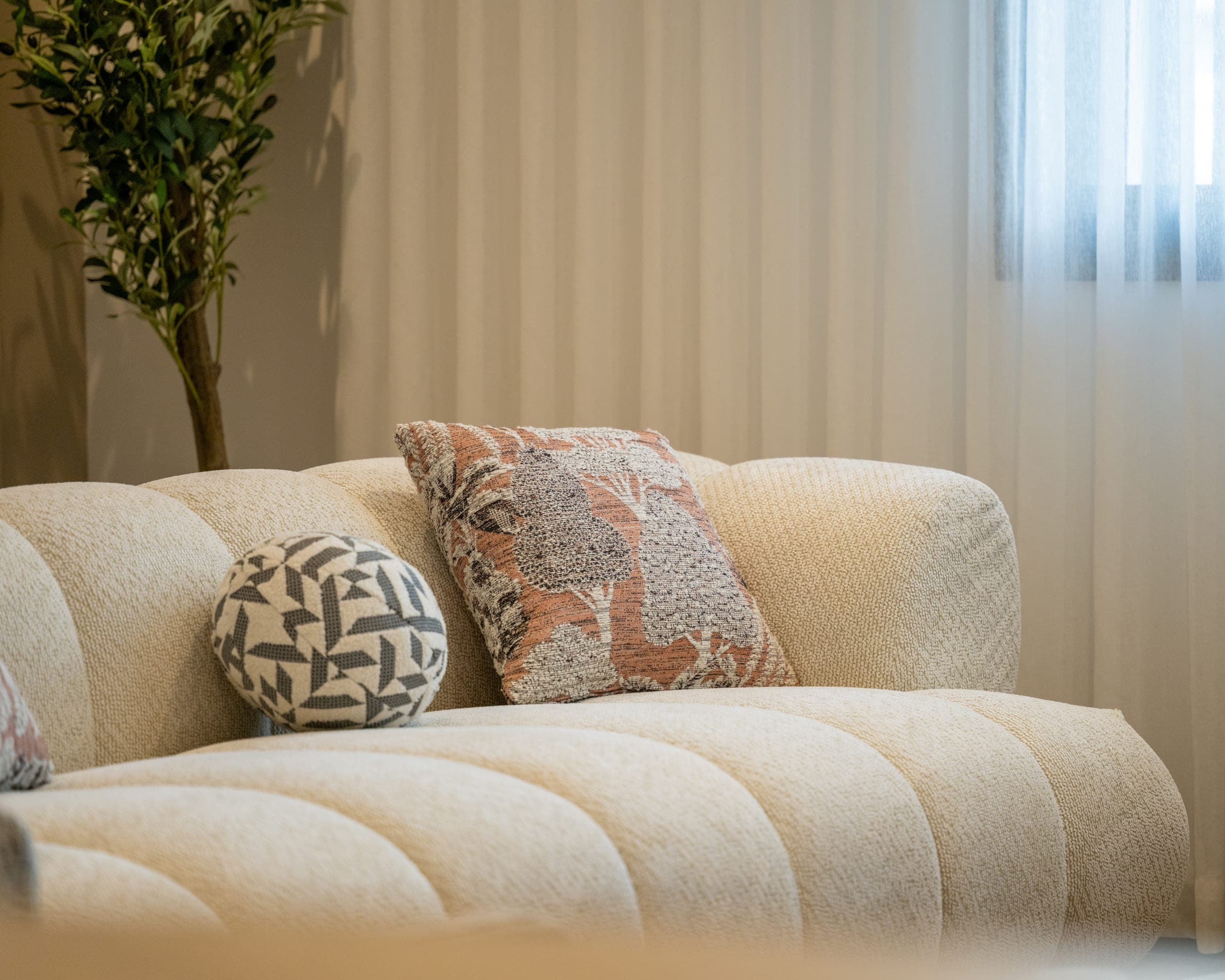 A sofa with patterned cushions in one of Ebhath's units